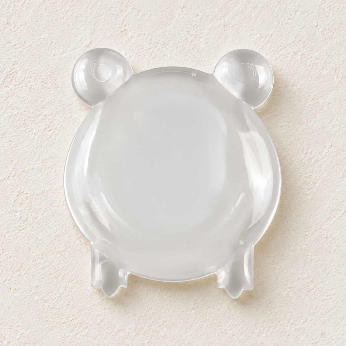 Clear frog-shaped silicone wall protector by Kindwall, cute for kids' rooms
